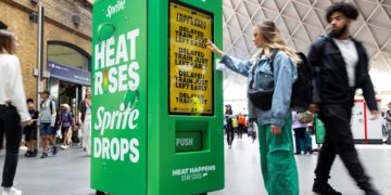 EDITORIAL USE ONLY 
Members of the public interact with prototype smart vending machine, as it is unveiled at London’s King’s Cross station by Sprite to bring to life their ‘Heat Happens’ campaign. Picture date: Wednesday July 12, 2023. PA Photo. The ‘smart vending machine’ uses live data to react to annoying moments of everyday commuter ‘heat’ - whether that’s ticket barrier bottlenecks, other people getting into your personal space or a train leaving 1 minute early - as the heat goes up, Sprite drops. Photo credit should read: David Parry/PA Wire
